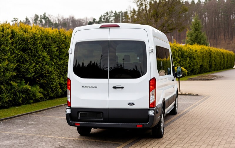 White Ford Transit minibus, rear view