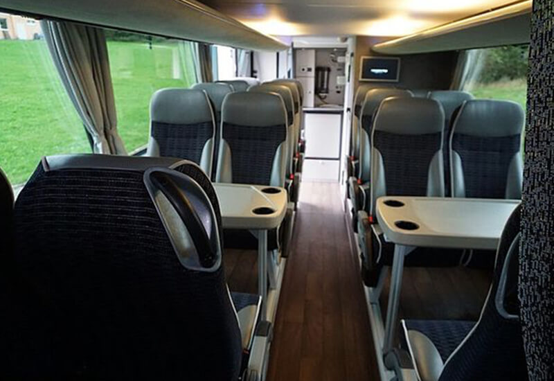 Seats around small tables in a Neoplan Skyliner